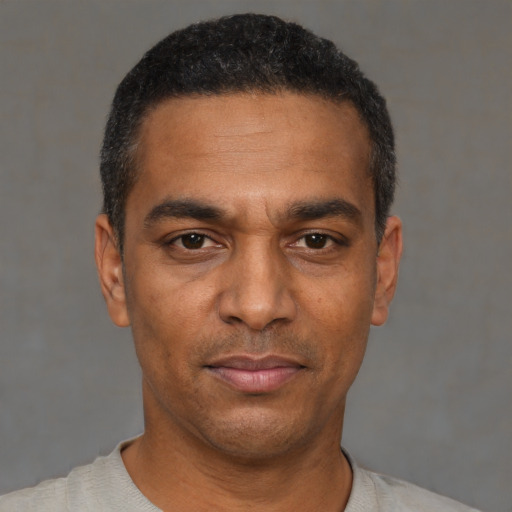 Neutral black adult male with short  black hair and brown eyes