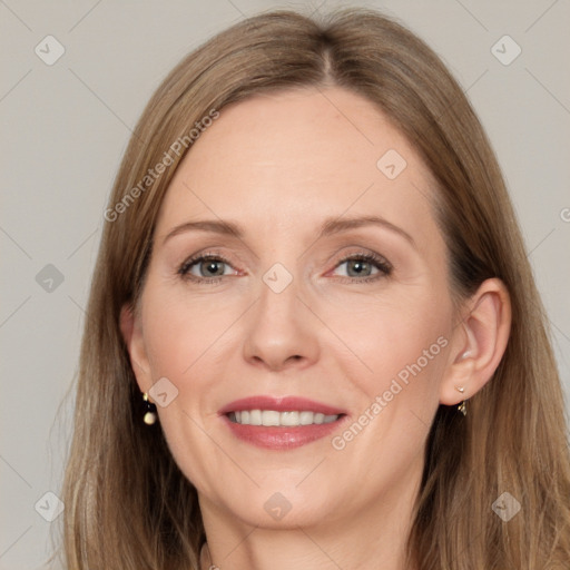 Joyful white adult female with long  brown hair and grey eyes