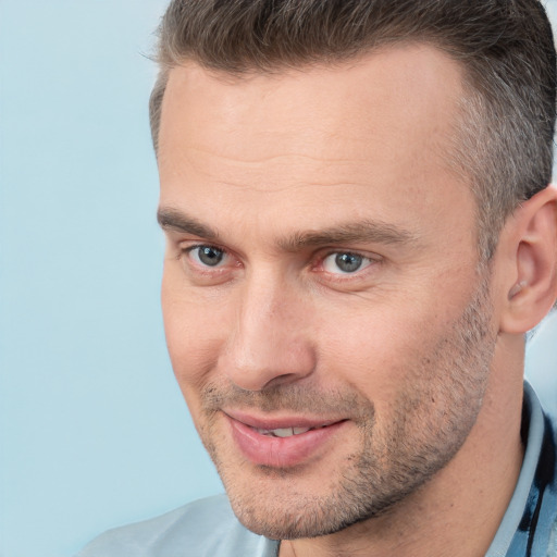 Joyful white adult male with short  brown hair and brown eyes