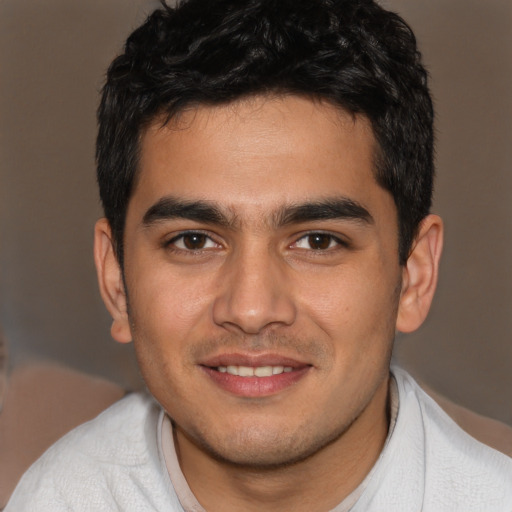 Joyful white young-adult male with short  black hair and brown eyes