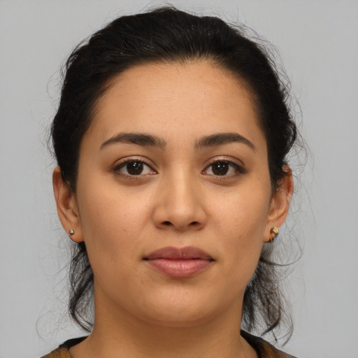 Joyful latino young-adult female with medium  brown hair and brown eyes