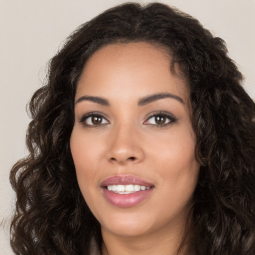 Joyful latino young-adult female with long  brown hair and brown eyes