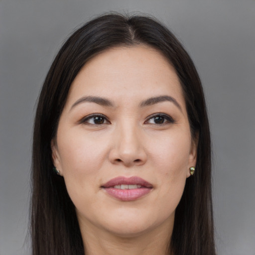Joyful asian young-adult female with long  brown hair and brown eyes