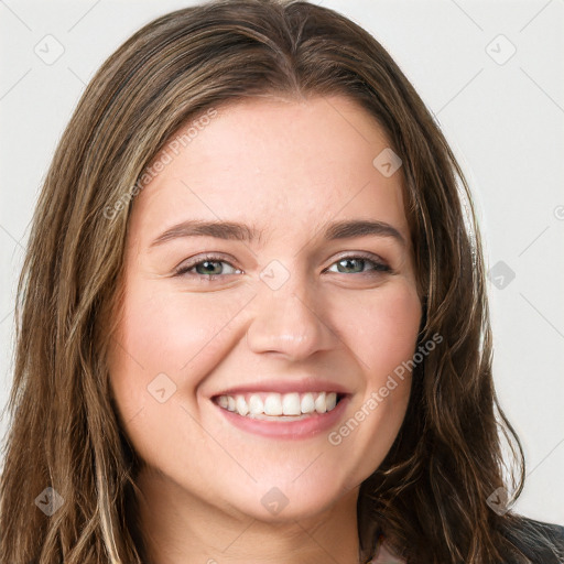 Joyful white young-adult female with long  brown hair and green eyes