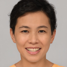 Joyful asian young-adult female with short  brown hair and brown eyes