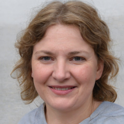 Joyful white young-adult female with medium  brown hair and blue eyes