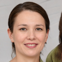 Joyful white young-adult female with medium  brown hair and brown eyes