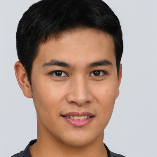 Joyful asian young-adult male with short  brown hair and brown eyes