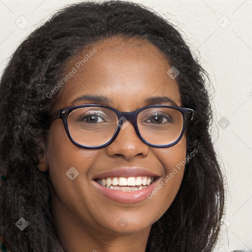 Joyful black young-adult female with long  brown hair and brown eyes