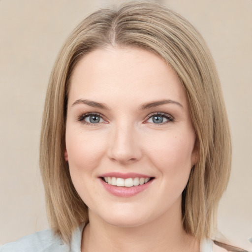 Joyful white young-adult female with medium  brown hair and green eyes