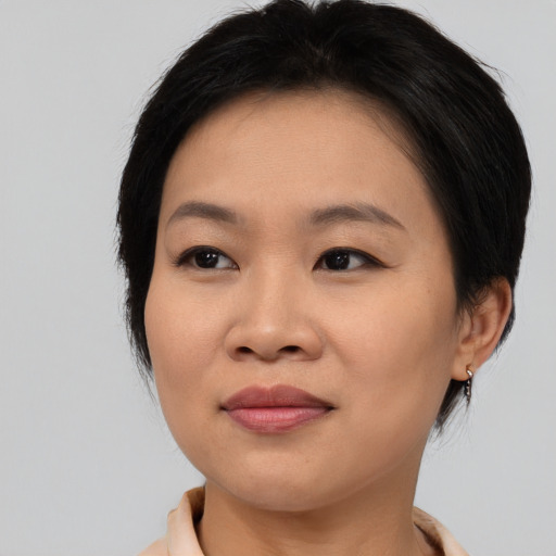 Joyful asian young-adult female with medium  brown hair and brown eyes
