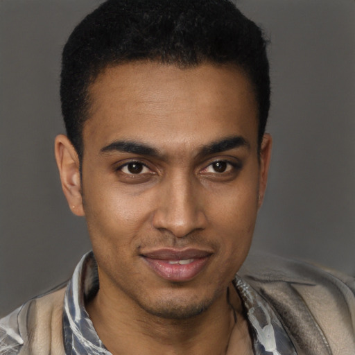Joyful black young-adult male with short  black hair and brown eyes