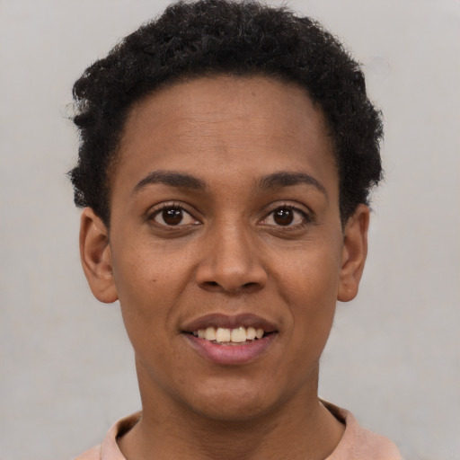 Joyful black young-adult female with short  brown hair and brown eyes
