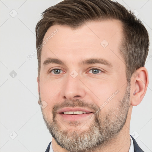 Joyful white adult male with short  brown hair and brown eyes