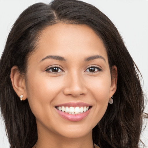 Joyful white young-adult female with long  brown hair and brown eyes