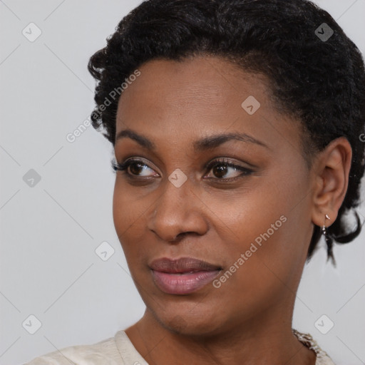 Joyful black young-adult female with short  black hair and brown eyes