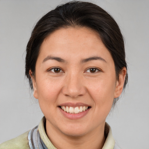 Joyful white adult female with medium  brown hair and brown eyes