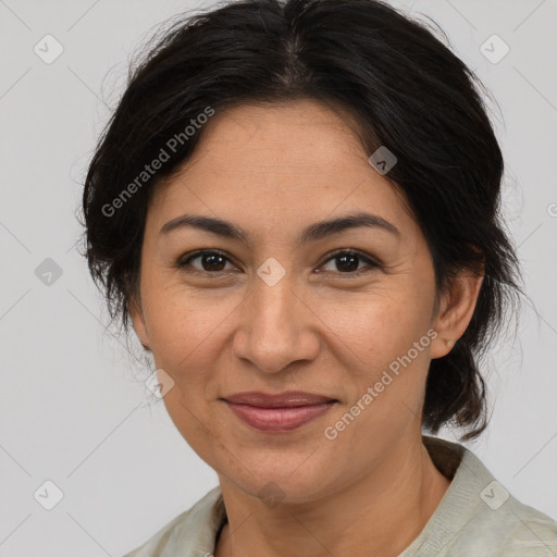 Joyful latino adult female with medium  brown hair and brown eyes