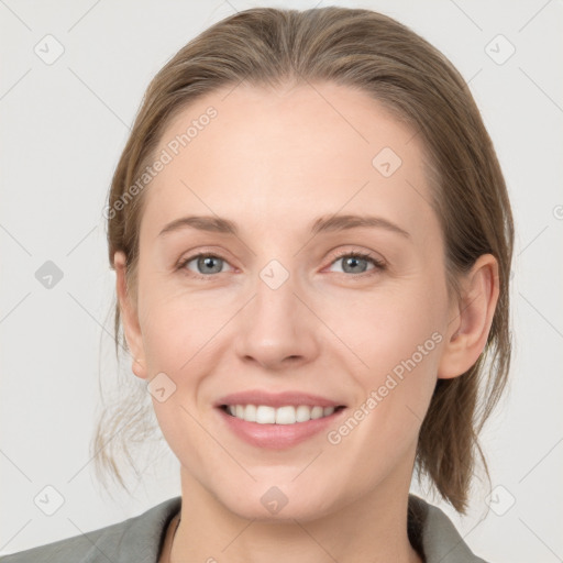 Joyful white young-adult female with medium  brown hair and grey eyes