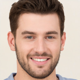 Joyful white young-adult male with short  brown hair and brown eyes