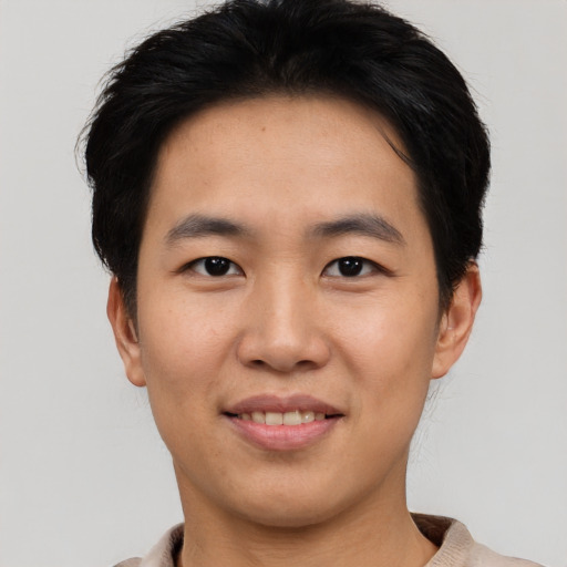 Joyful asian young-adult male with short  black hair and brown eyes