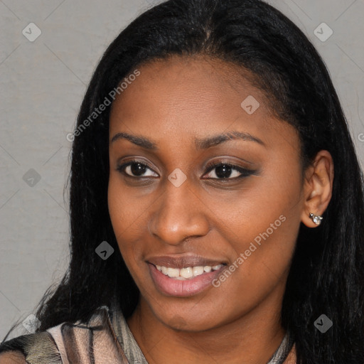 Joyful black young-adult female with long  black hair and brown eyes