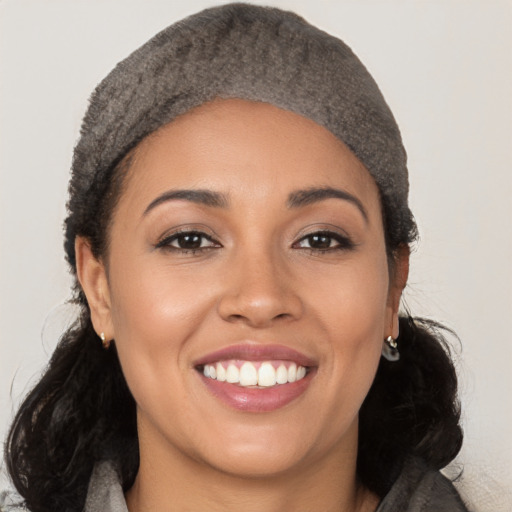 Joyful latino young-adult female with medium  black hair and brown eyes