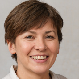 Joyful white adult female with medium  brown hair and brown eyes