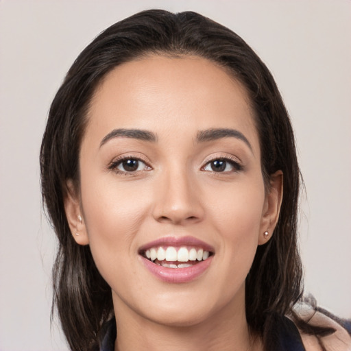 Joyful white young-adult female with long  brown hair and brown eyes