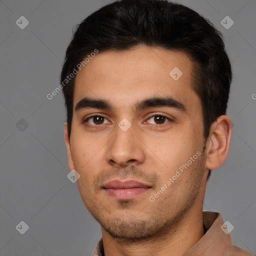 Joyful white young-adult male with short  black hair and brown eyes