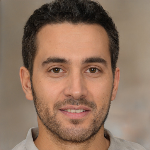 Joyful white young-adult male with short  brown hair and brown eyes