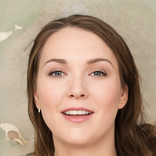 Joyful white young-adult female with long  brown hair and green eyes