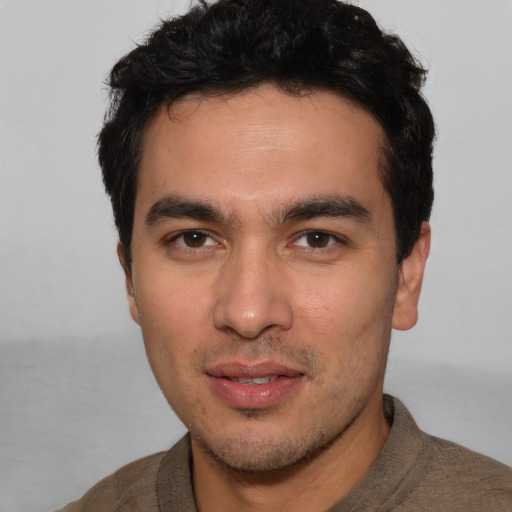 Joyful white young-adult male with short  black hair and brown eyes