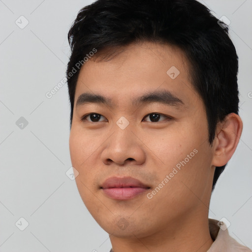 Joyful asian young-adult male with short  black hair and brown eyes