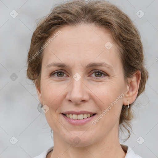 Joyful white adult female with medium  brown hair and grey eyes