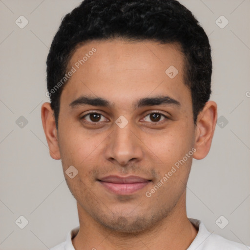 Joyful latino young-adult male with short  black hair and brown eyes