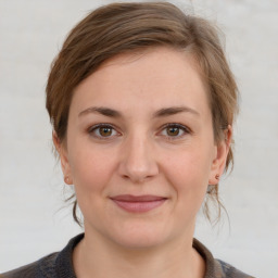 Joyful white young-adult female with medium  brown hair and grey eyes