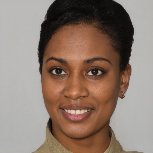 Joyful black young-adult female with short  brown hair and brown eyes