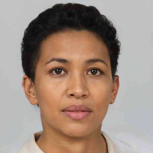 Joyful latino adult female with short  brown hair and brown eyes