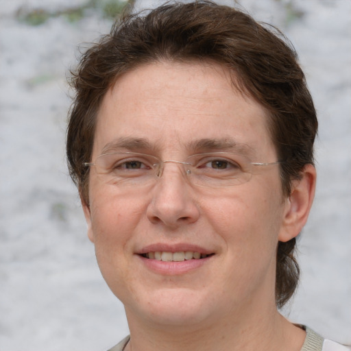 Joyful white adult female with short  brown hair and grey eyes