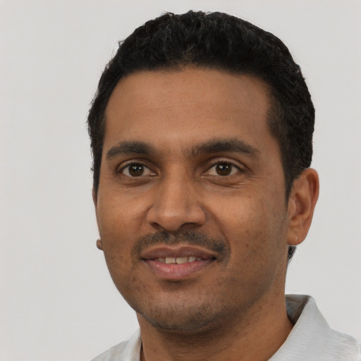 Joyful black young-adult male with short  black hair and brown eyes