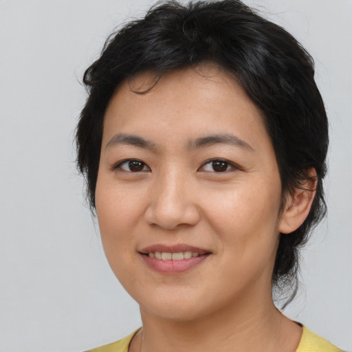 Joyful asian young-adult female with medium  brown hair and brown eyes