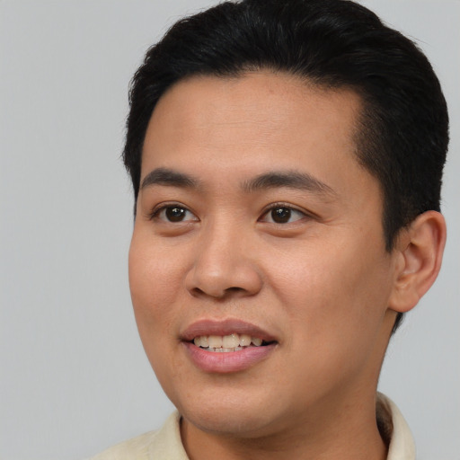 Joyful asian young-adult male with short  brown hair and brown eyes