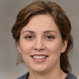 Joyful white young-adult female with medium  brown hair and grey eyes