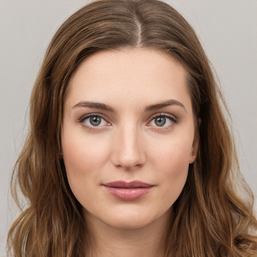 Joyful white young-adult female with long  brown hair and green eyes