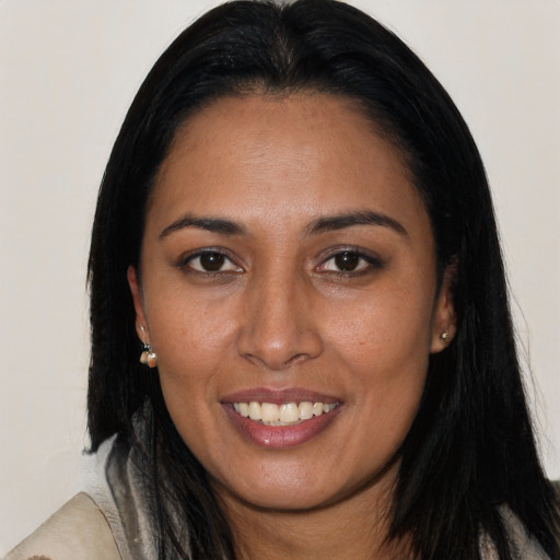 Joyful latino young-adult female with long  black hair and brown eyes