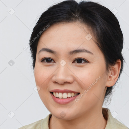 Joyful asian young-adult female with medium  brown hair and brown eyes