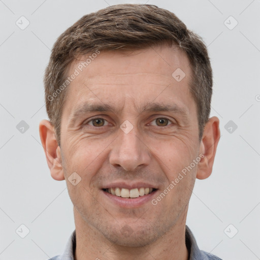 Joyful white adult male with short  brown hair and grey eyes