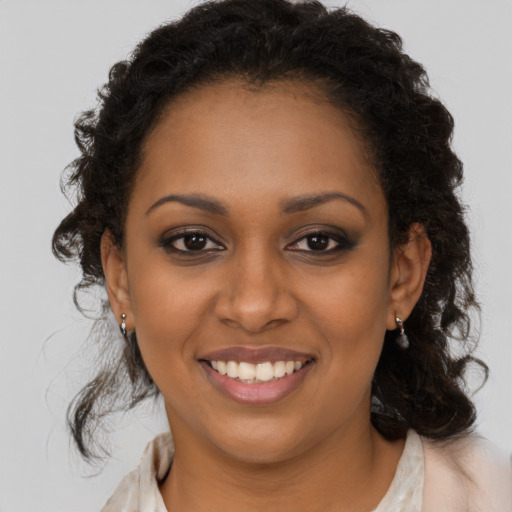 Joyful black young-adult female with medium  brown hair and brown eyes