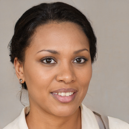 Joyful black young-adult female with medium  brown hair and brown eyes